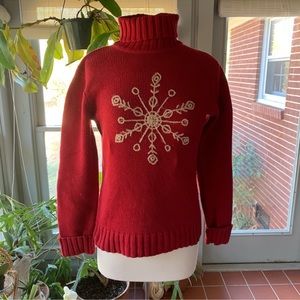 Red turtleneck sweater with embroidered snowflake